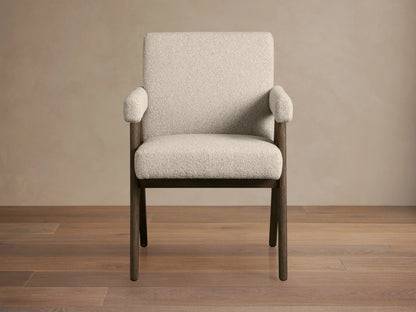 Stanley Dining Arm Chair in Mocha with oak wood frame and ecru fabric, angled view on wooden floor.