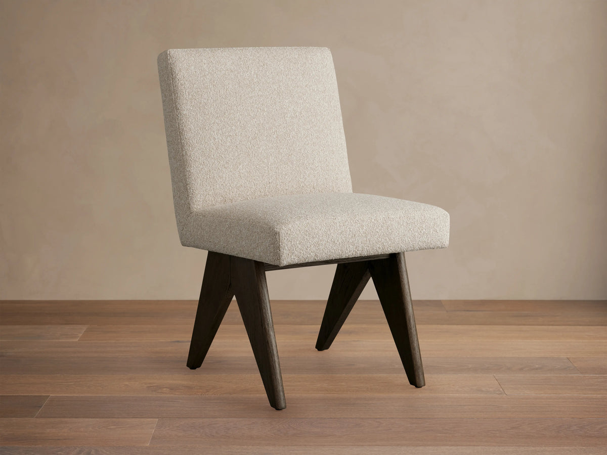 Stanley Dining Side Chair in Mocha with ecru fabric, featuring oak wood legs. Chair is angled slightly left on a wooden floor.