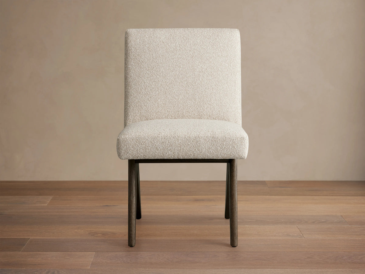 Stanley Dining Side Chair in Mocha with ecru fabric, featuring oak wood legs. Chair is angled slightly left on a wooden floor.