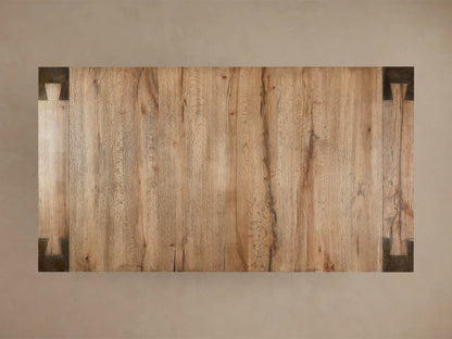 Telluride Dining Table corner showing solid oak top with natural grain and distressed steel leg featuring unique dimpled texture.