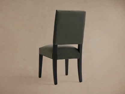 Torino Dining Chair with a plush grey upholstered seat and back, featuring sleek black solid maple tapered legs, angled for stability.