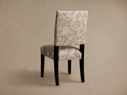 Torino Dining Chair seat with intricate floral upholstery in beige and brown tones. Visible backrest in the background.