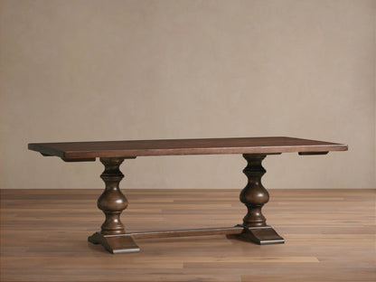 Tuscany Oval Extension Dining Table with rich brown finish, hand-turned pedestal legs and horizontal trestle on a wooden floor.