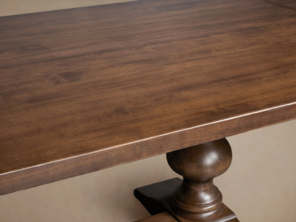 Tuscany Oval Extension Dining Table features a warm brown poplar wood tabletop with visible grain, and a hand-turned pedestal leg.