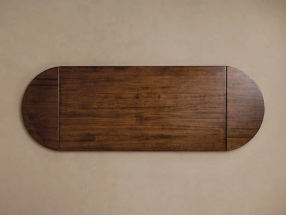 Tuscany Oval Extension Dining Table's rich brown poplar wood tabletop, showcasing warm coloring and fine grain against a neutral background.