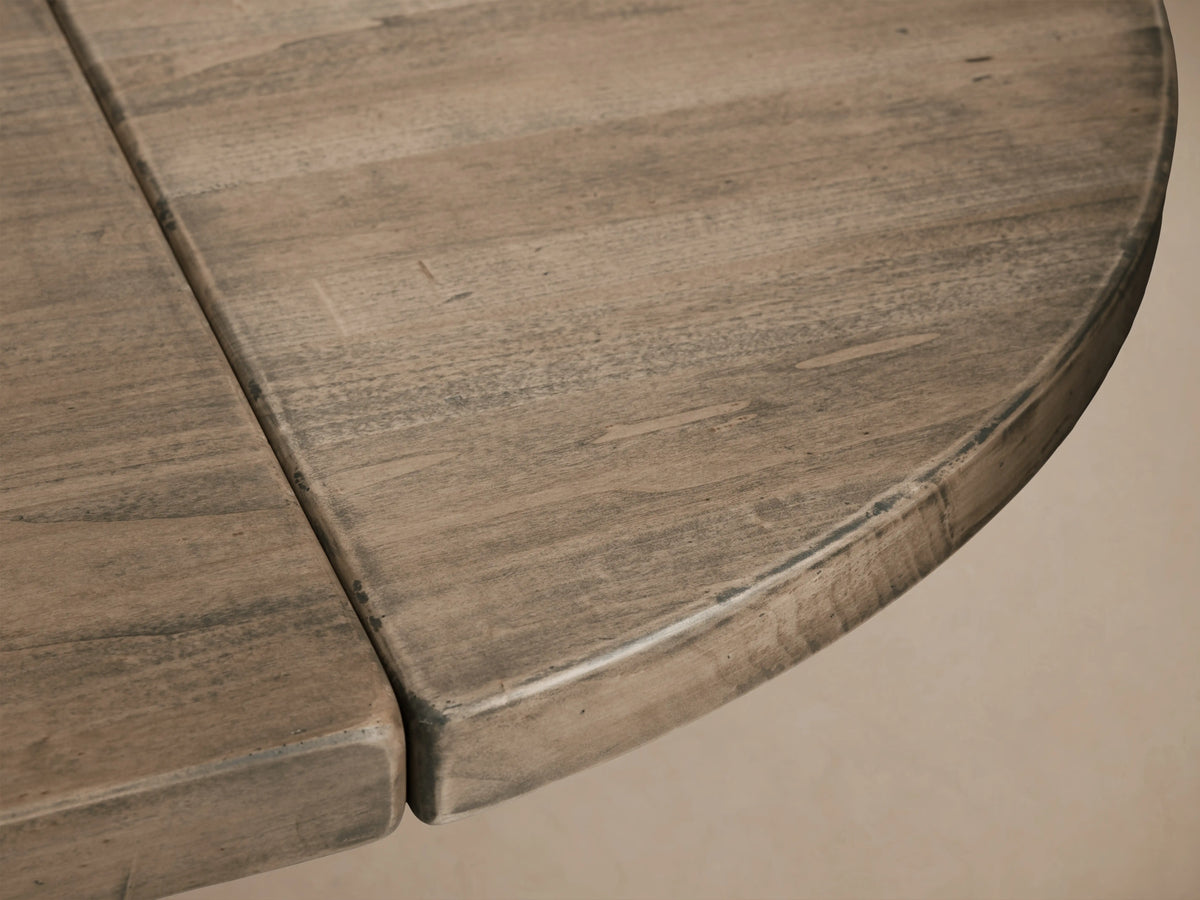 Tuscany Oval Extension Dining Table in solid poplar wood with hand-turned pedestal legs and horizontal trestle on wood floor.
