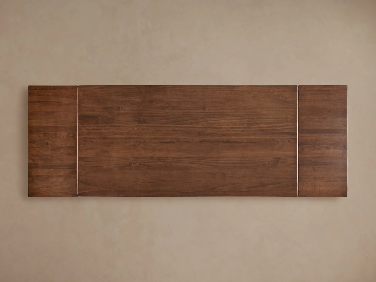 Tuscany Extension Dining Table with a rectangular solid poplar wood tabletop, showcasing a warm, rich brown grain texture, viewed from above.