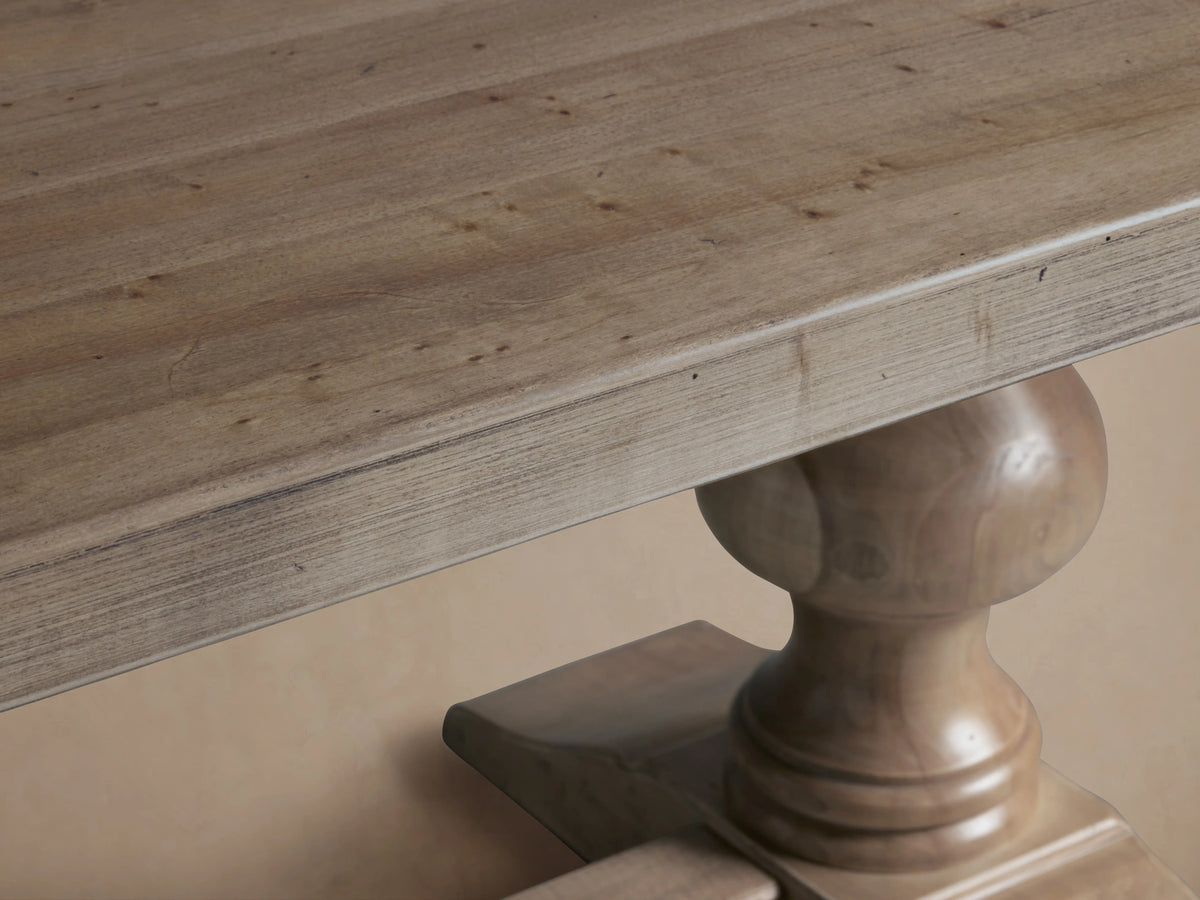 Tuscany Oval Extension Dining Table with a long rectangular top, hand-turned pedestal legs, and a connecting trestle. Distressed wood finish.