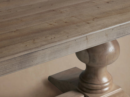 Tuscany Oval Extension Dining Table with a long rectangular top, hand-turned pedestal legs, and a connecting trestle. Distressed wood finish.