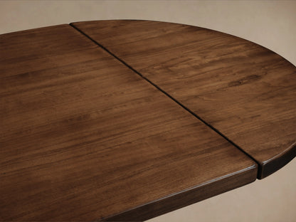 Tuscany Oval Extension Dining Table in warm poplar wood finish, showing smooth tabletop with hand-turned pedestal legs and subtle grain texture.