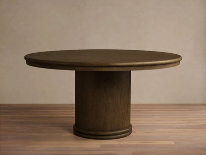Front view of a mocha-toned Warby Round Dining Table, featuring a smooth round top and a thick cylindrical pedestal base.