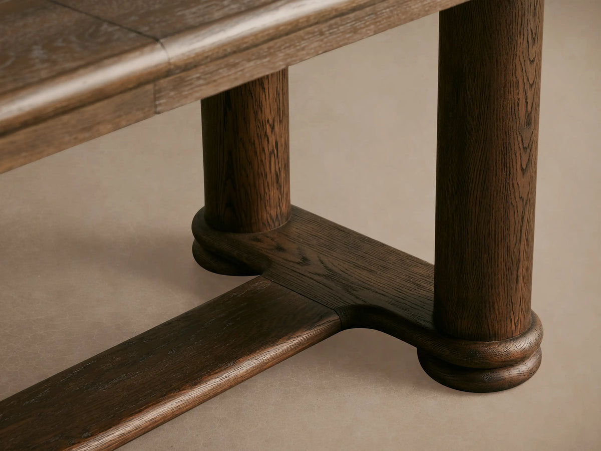 Warby Extension Dining Table in dark wood finish, featuring a rectangular top and dual pedestal base, set on a wooden floor.