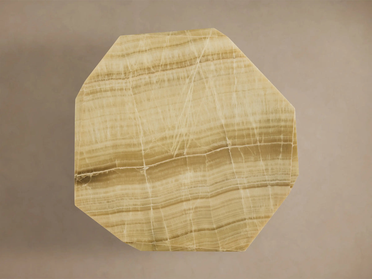 Top-down view of the Zyra Round Dining Table's asymmetrical solid green onyx tabletop with natural beige and brown bands.
