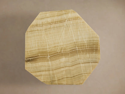 Top-down view of the Zyra Round Dining Table's asymmetrical solid green onyx tabletop with natural beige and brown bands.