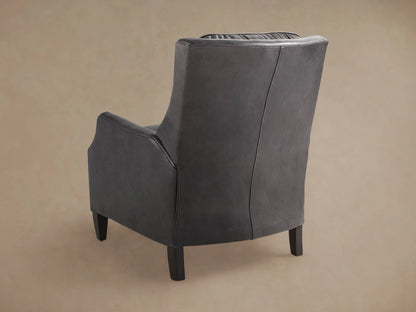 Close-up of Alex Leather Recliner's armrest, showing rich, dark grey textured leather and piping details.