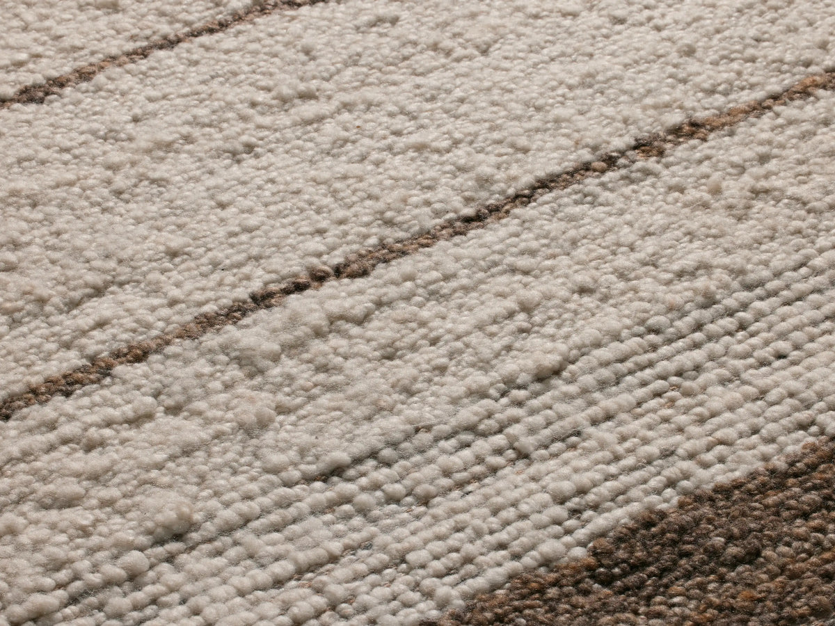 Alice Performance Rug, overhead view of a cream rug with vertical brown stripes and textured brown borders.