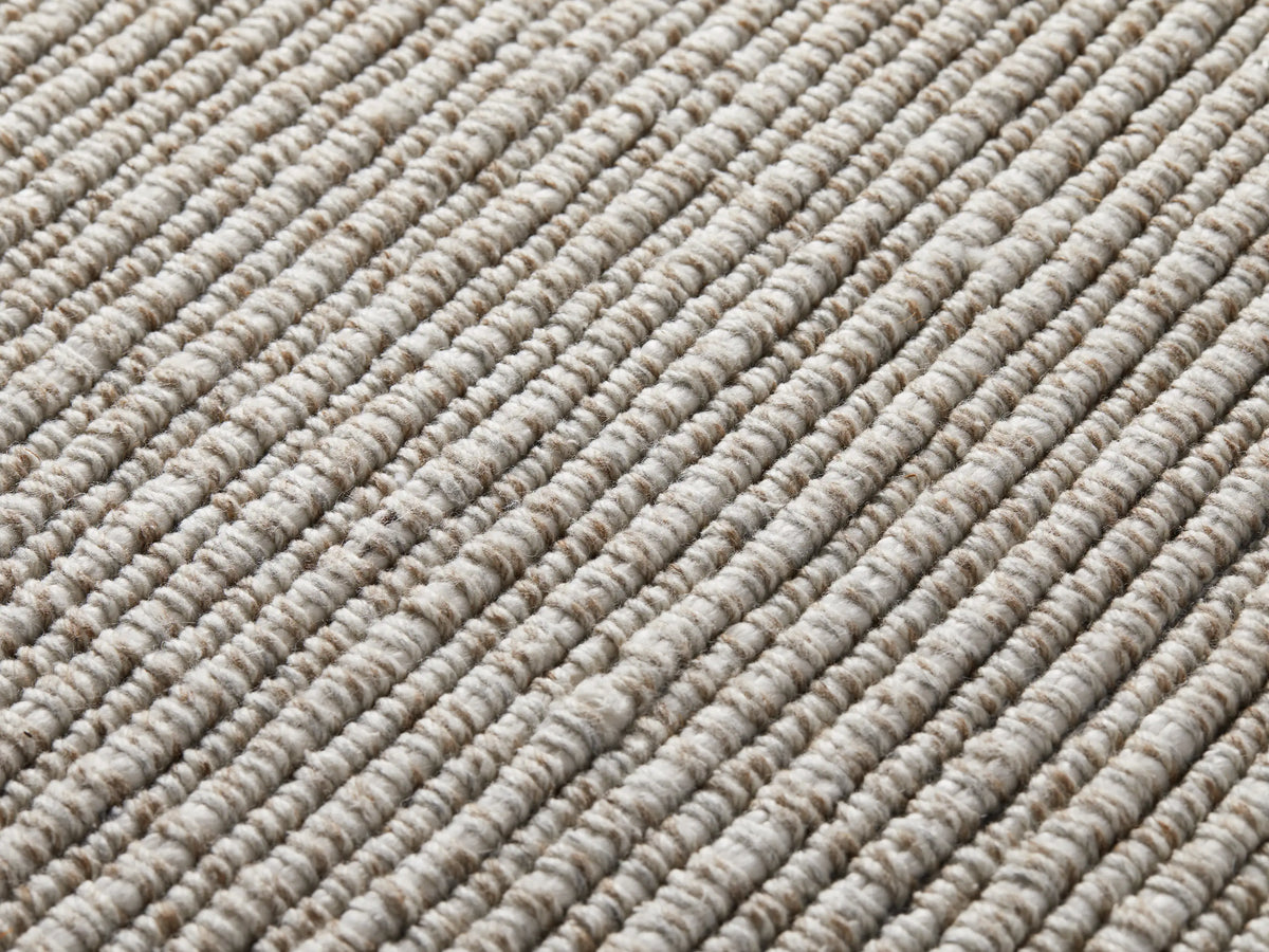 Dover Performance Rug, close-up of light beige and brown heathered ribbed texture with distinct diagonal stripes.