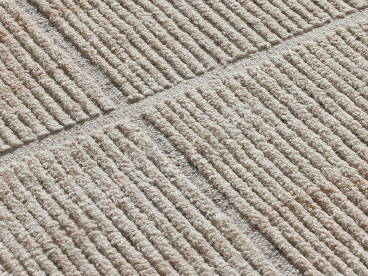 Walker Performance Rug: Light beige, rectangular, with a subtle grey geometric line pattern and visible woven texture, flat lay.