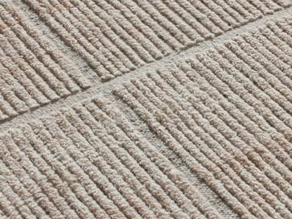 Walker Performance Rug: Light beige, rectangular, with a subtle grey geometric line pattern and visible woven texture, flat lay.