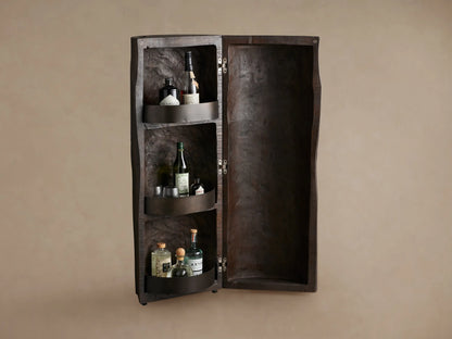 Closed Log Bar, upright, dark brown reclaimed wood, textured like a natural log, on a brown wooden floor against a beige wall.