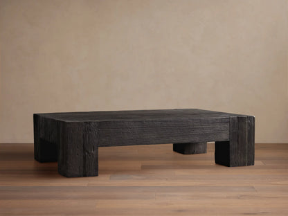 Ubud Coffee Table, square and low, made of dark reclaimed teak wood with prominent grain texture, on a wood floor.
