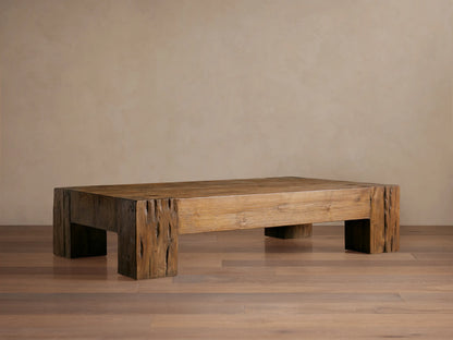 Ubud Coffee Table: Low, rectangular reclaimed teak wood table with thick, textured, warm brown block legs.