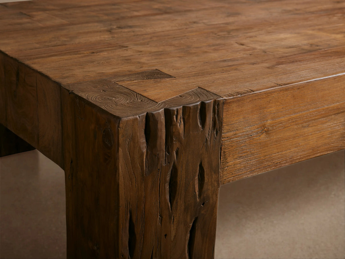 Ubud Coffee Table, a rectangular reclaimed teak wood table with warm brown tones, natural splits & knots, on a wooden floor.