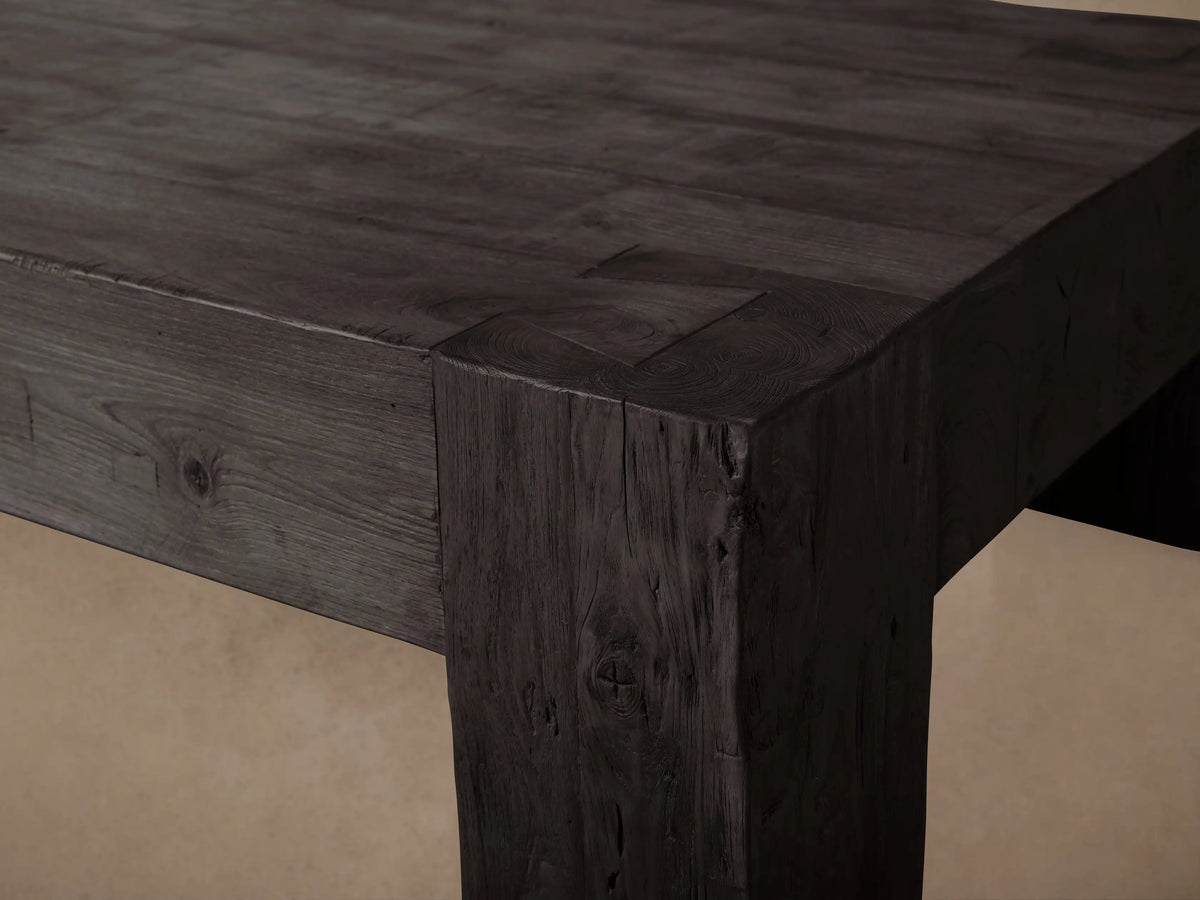 Ubud Coffee Table, dark rectangular reclaimed teak with thick block legs and textured, charred Shou Sugi Ban finish on a wood floor.
