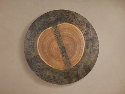 Close-up of the Acacius Round Coffee Table, featuring a top with natural wood grain patterns and oxidized steel edges in a weathered finish.