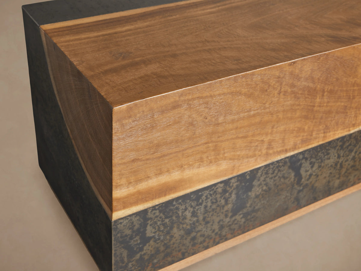 Acacius End Table with natural wood grain and textured oxidized steel band. Rectangular shape on wooden floor.