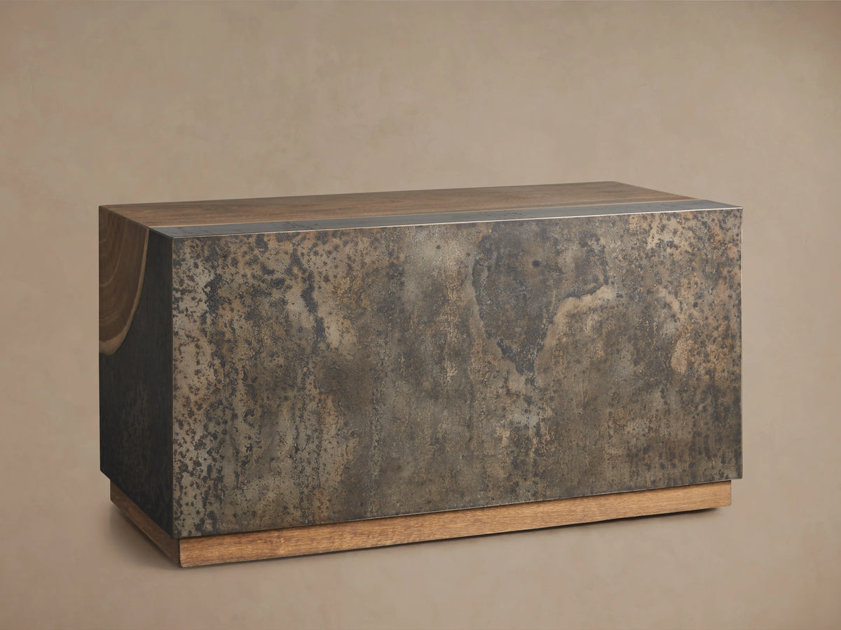Acacius End Table with a rich, natural wood grain top and a base of oxidized steel with a weathered appearance, showing unique textures.
