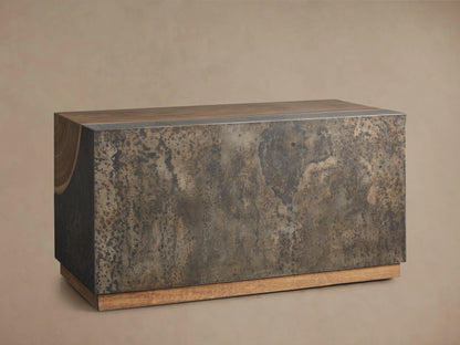 Acacius End Table with a rich, natural wood grain top and a base of oxidized steel with a weathered appearance, showing unique textures.