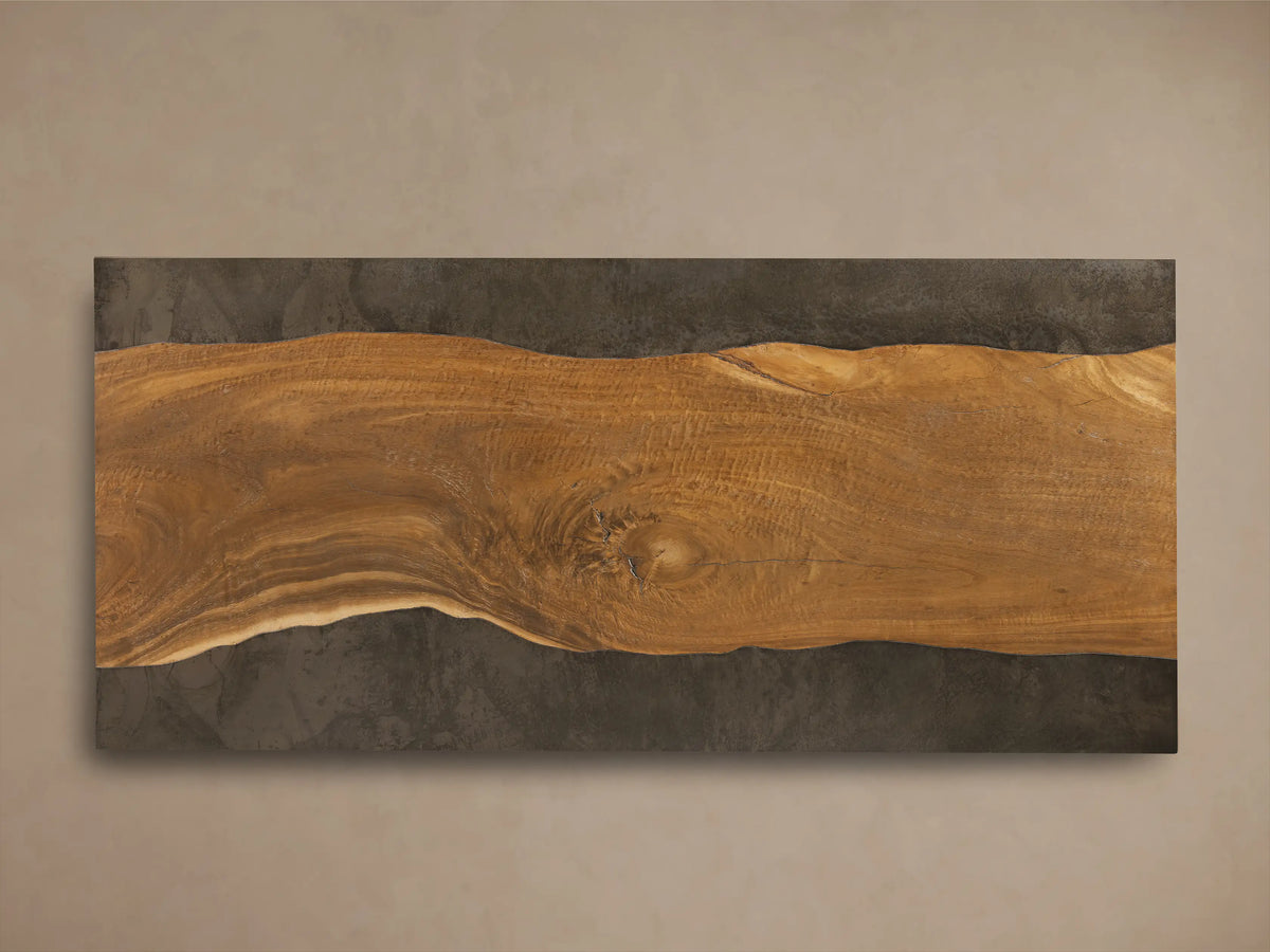 Angled view of Acacius Long Coffee Table, featuring dark oxidized steel and warm brown wood top with prominent natural growth rings.
