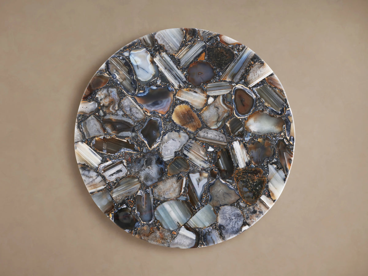 Ludlow Martini Table with a round tabletop featuring a mosaic of polished stones in varying natural tones, set against a neutral background.
