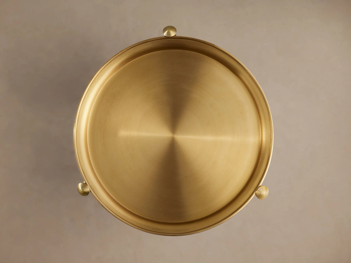 Albie Martini Table features intersecting gold metal rods connected by a decorative ring, showcasing a sleek and elegant design.