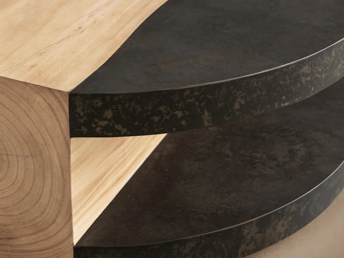 Close-up of the Almeria Round Coffee Table, showing natural guanacaste wood and dark oxidized steel with distressed patinas.