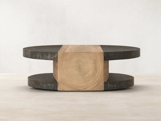 Front view of Almeria Round Coffee Table. Dark oxidized steel discs and angled guanacaste wood block with end grain.