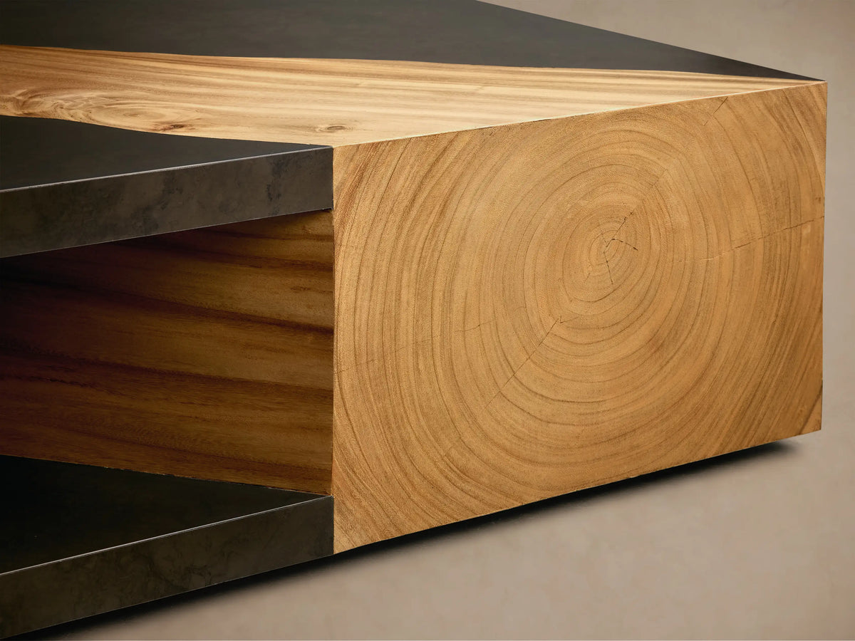 Front view of the geometric Almeria Coffee Table, featuring warm brown guanacaste wood veneers and dark gray oxidized steel with wood grain.
