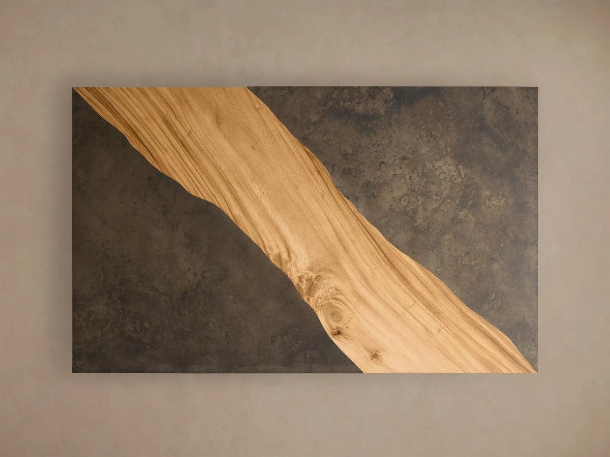 Close-up of the corner of the Almeria Coffee Table, showing light brown guanacaste wood with growth rings and dark oxidized steel panels.