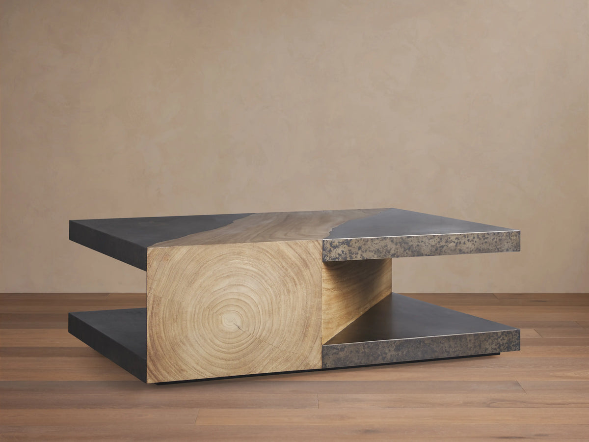 Almeria Coffee Table with a rectangular shape, featuring guanacaste wood and oxidized steel. Steel panels show a distressed patina.
