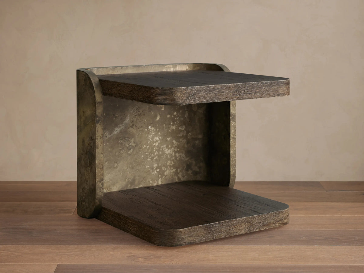 Dark brown Alvaro End Table with a subtle sheen, visible wood grain, and an open shelf, positioned by a brown sectional sofa.