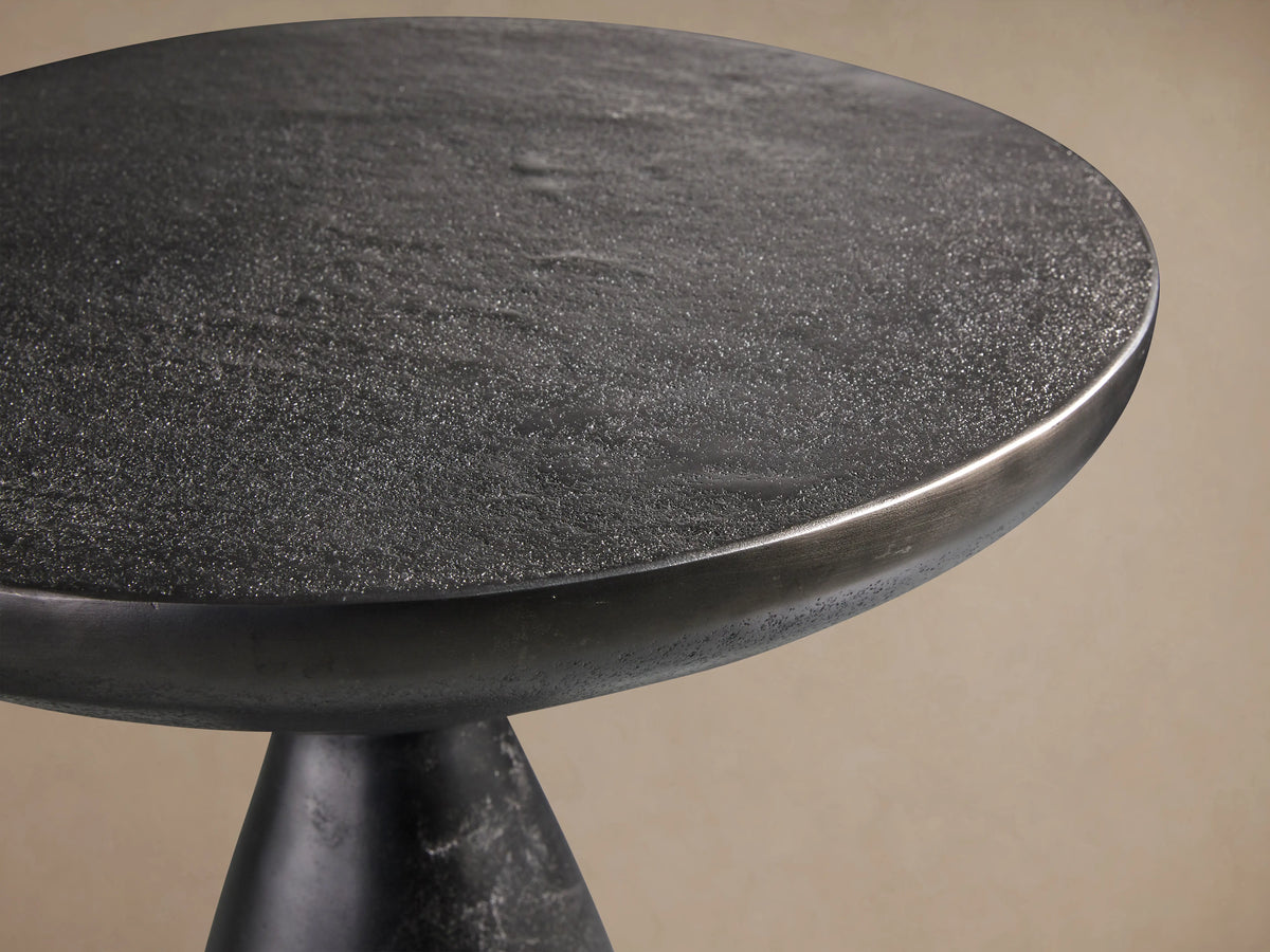 Amina End Table in a dark nickel finish, featuring a drip texture. Cone-shaped base supports a wide, flat top.