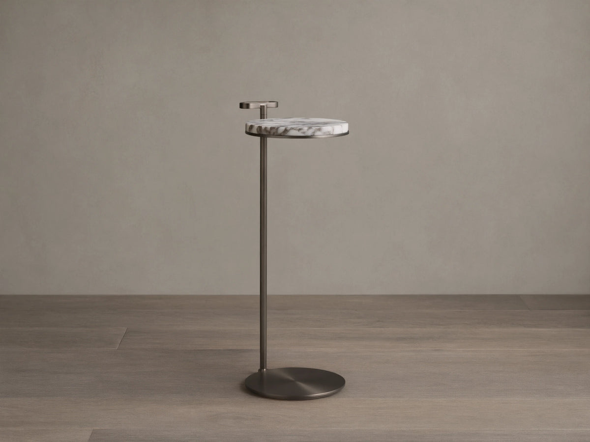Front view of Anorah Martini Table with a round white marble top featuring gray veining, a dark metallic stand, and integrated handle.