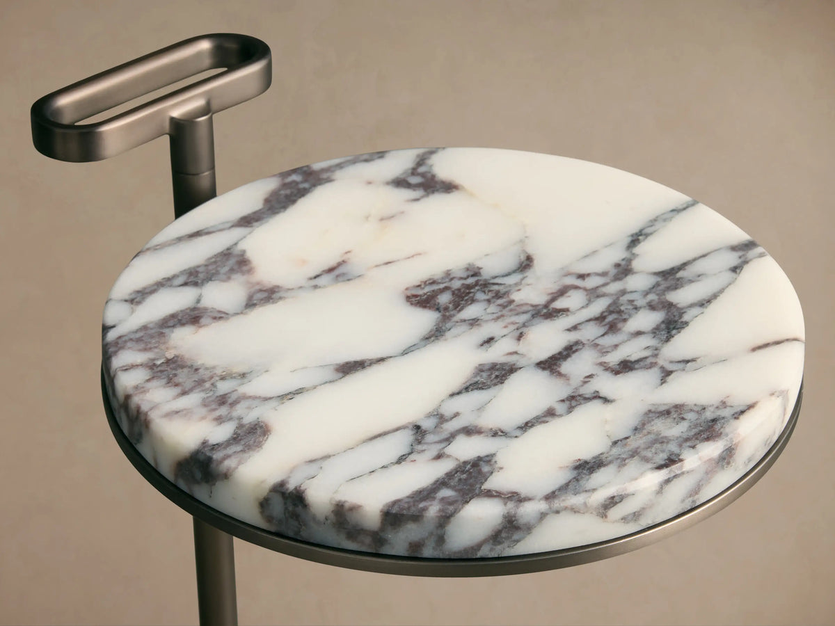 Front view of Anorah Martini Table with a round white marble top featuring gray veining, a dark metallic stand, and integrated handle.