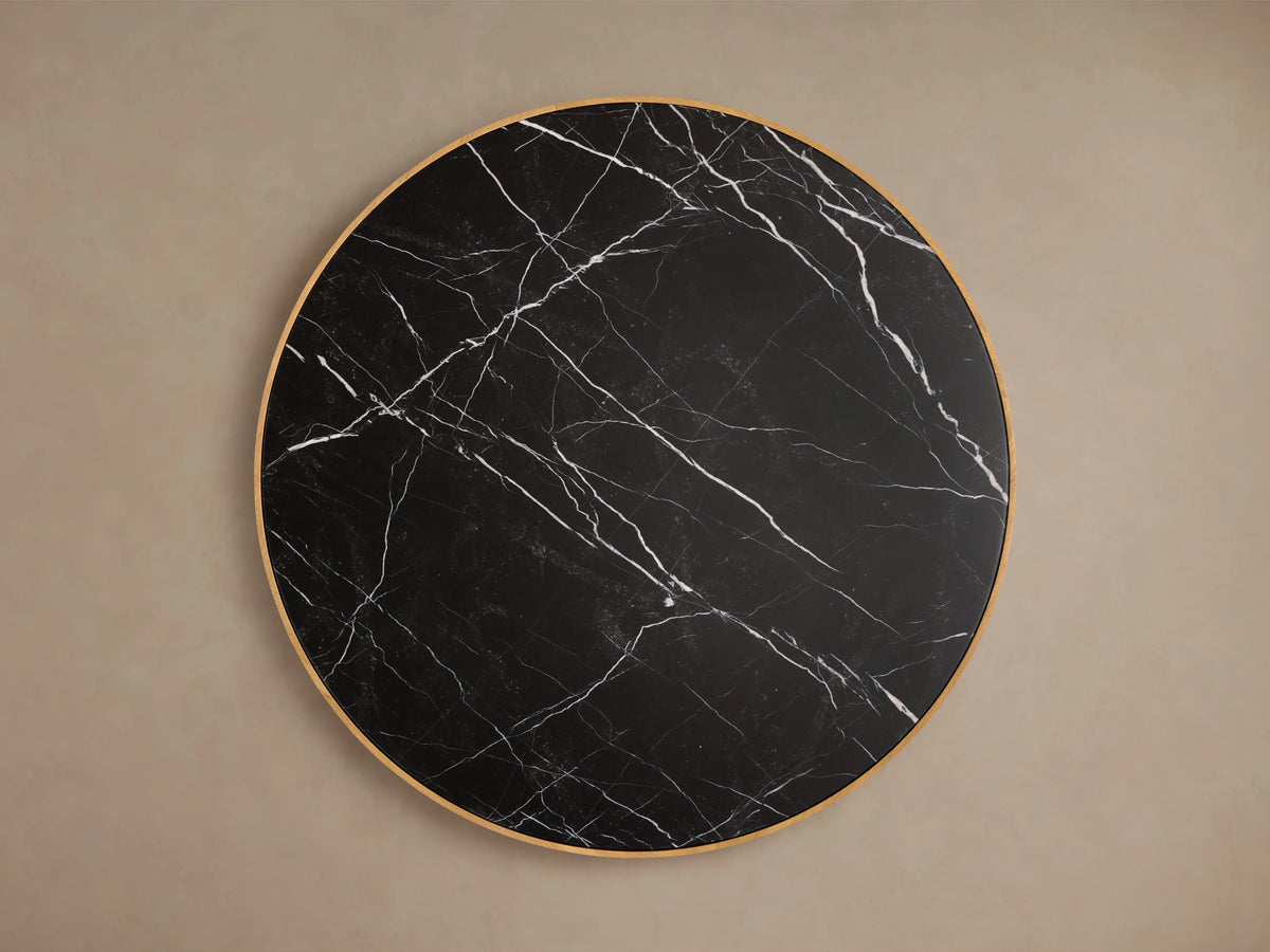 Astor Round Coffee Table with a black marble top featuring white veining, supported by a textured oak reed-wrapped base.