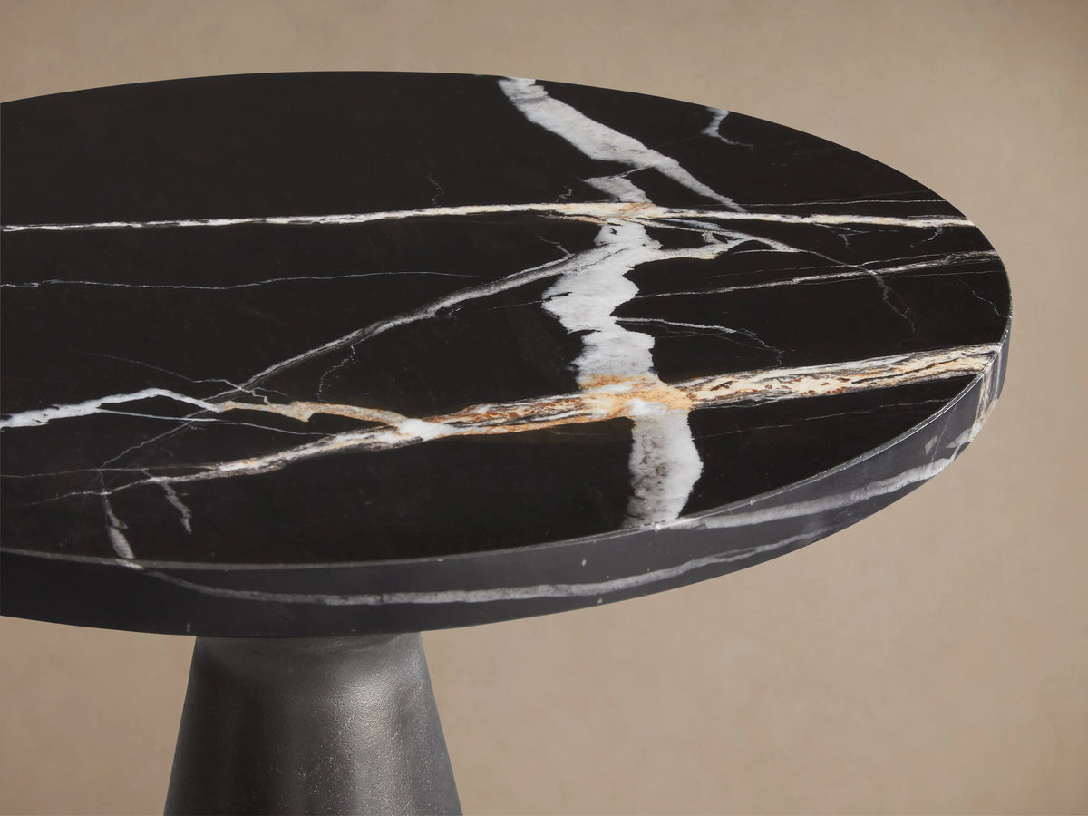 Beaufort Martini Table: Round black marble top with striking white and gold veining, dark gray base.