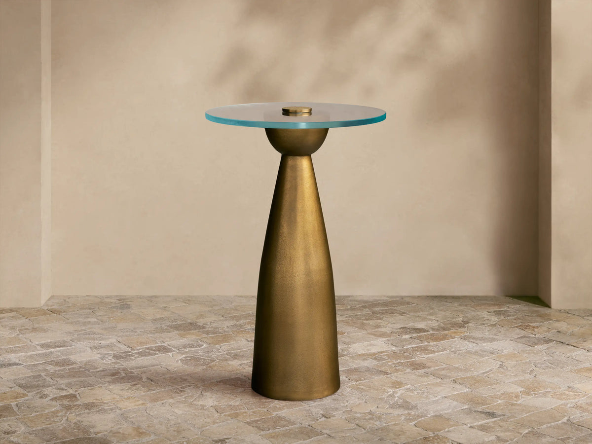 Front view of the Antique Brass Beaufort Glass Top Martini Table, featuring a round glass top and tapered base.