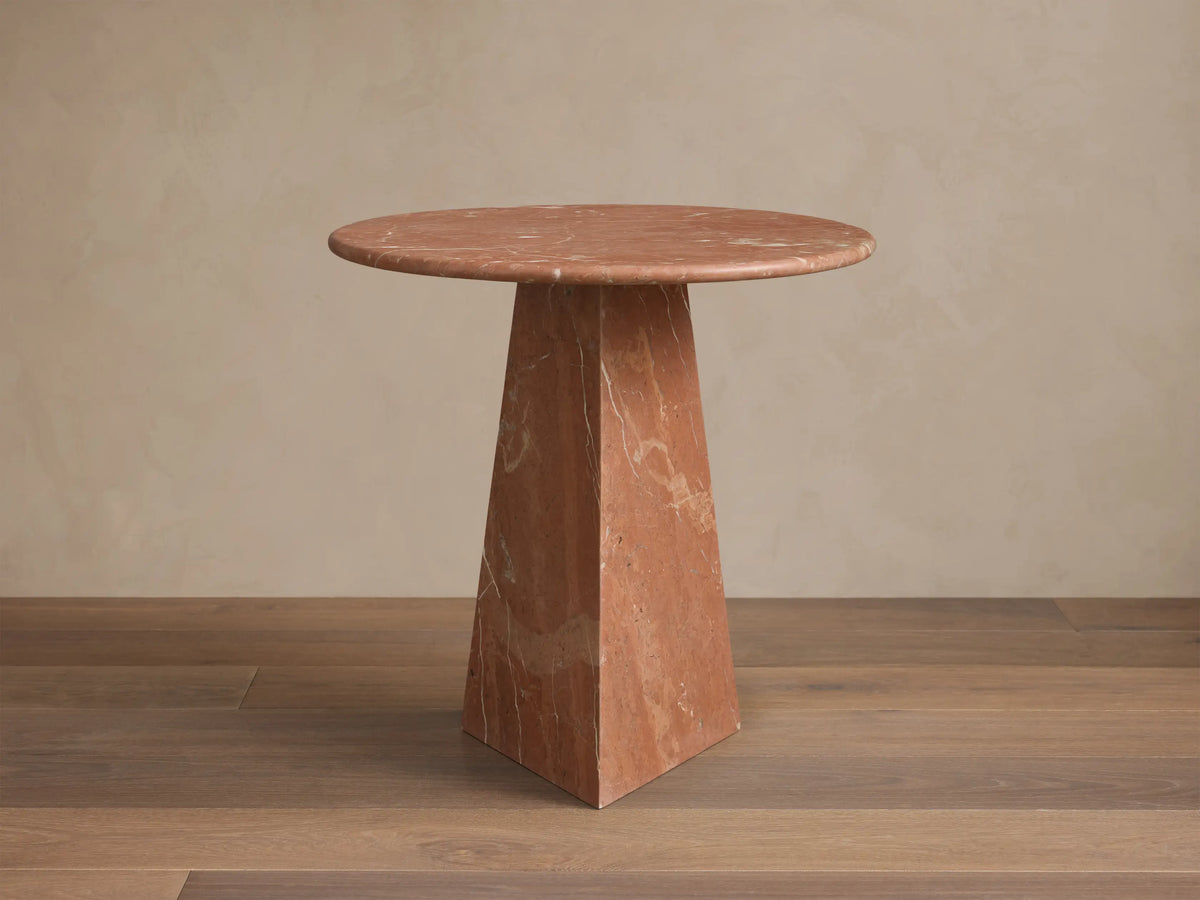 Front view of the reddish-brown marble Brecken End Table with a round top, tapering faceted base, and white veining.