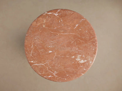 Close-up of the reddish-brown Brecken End Table's marble top and base, with distinct white veining.