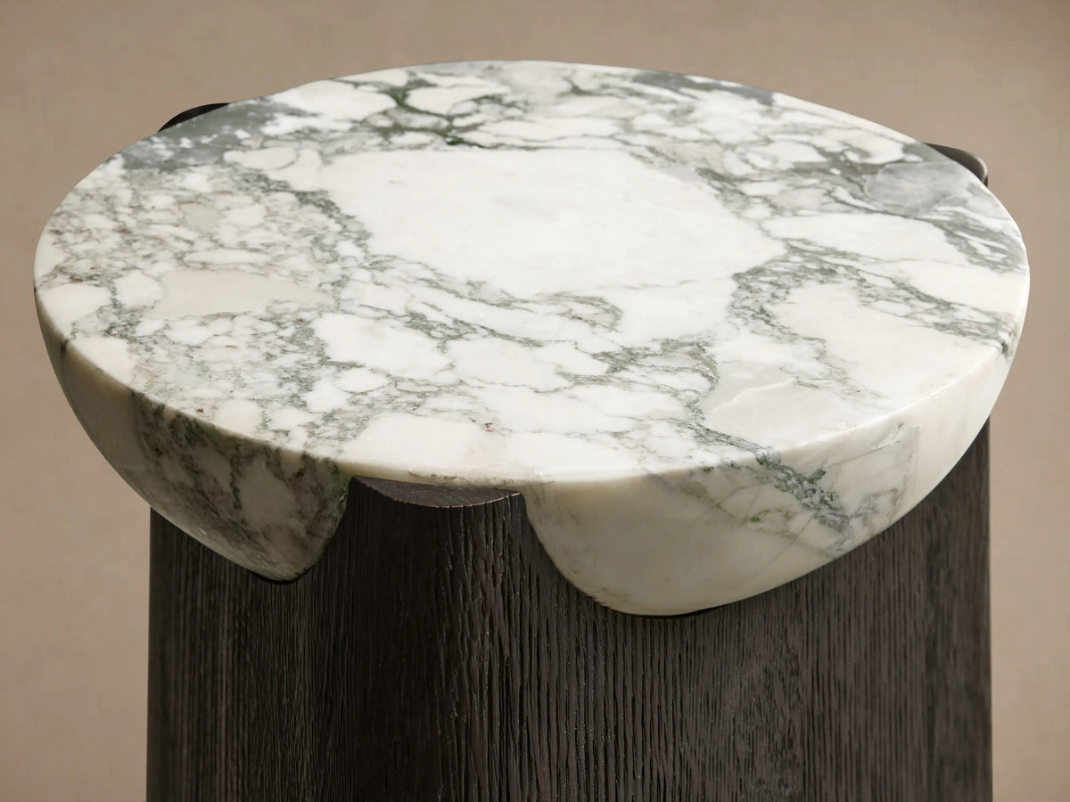 Bellino Martini Table with dark, softly rounded triangular oak base and nested white marble top with grey veining.